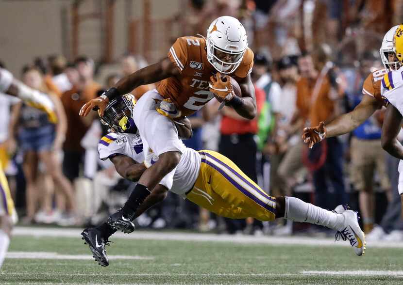 AUSTIN, TX - SEPTEMBER 07:  Roschon Johnson #2 of the Texas Longhorns is tackled by Grant...