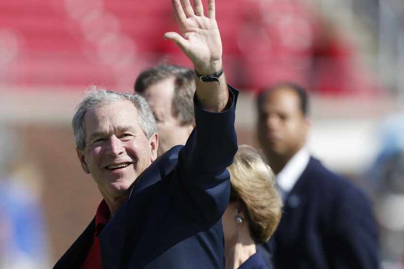 Former United States President George W. Bush leaves the field after the coin flip prior to...