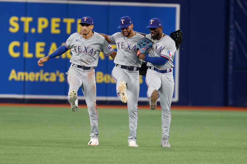 Texas Rangers outfielders Bubba Thompson, Leody Taveras and Adolis Garcia, from left,...