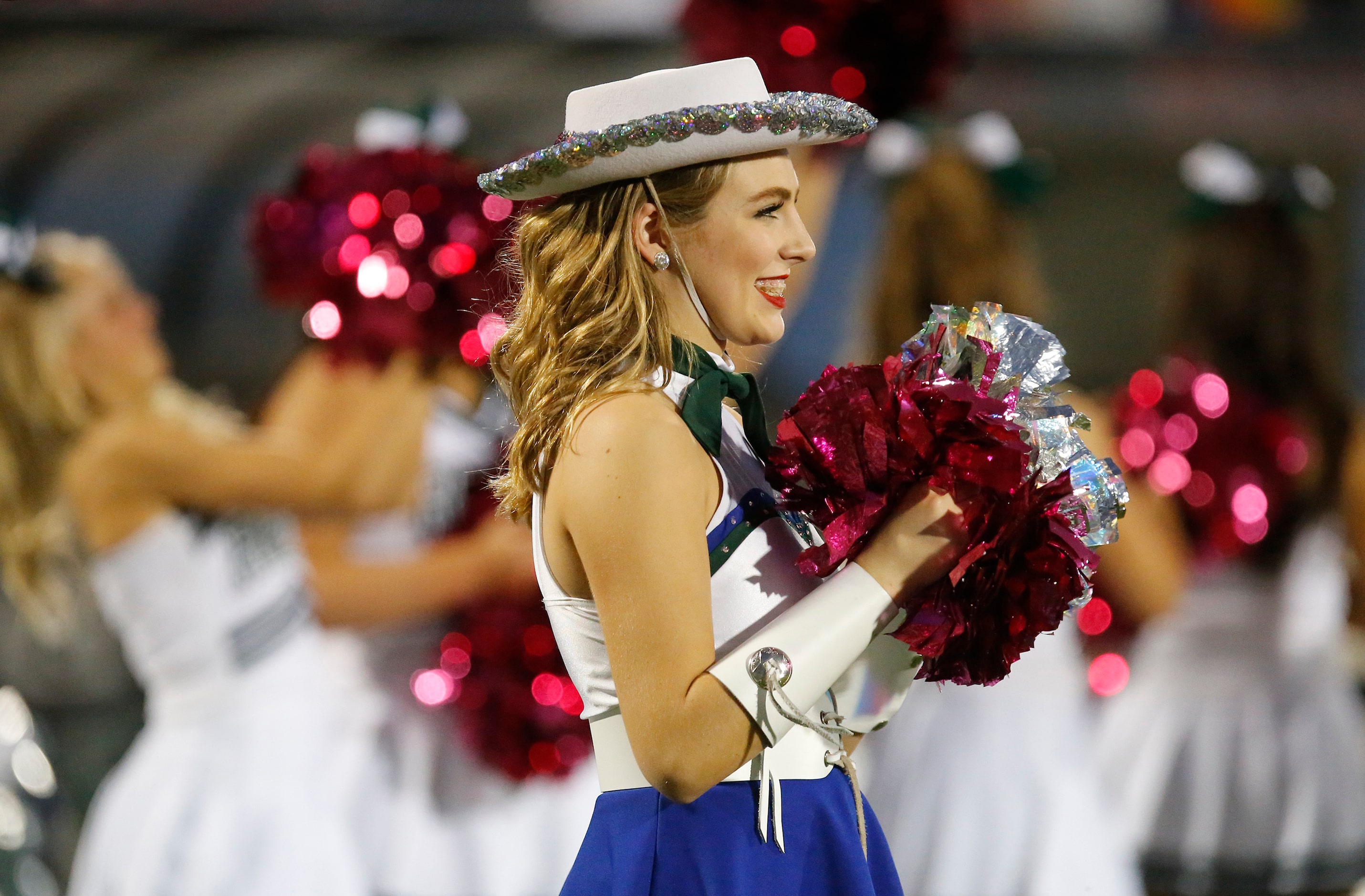 Jaynie Sanovich, 14, a member of the Reedy High School Saphires drill team, cheers after the...