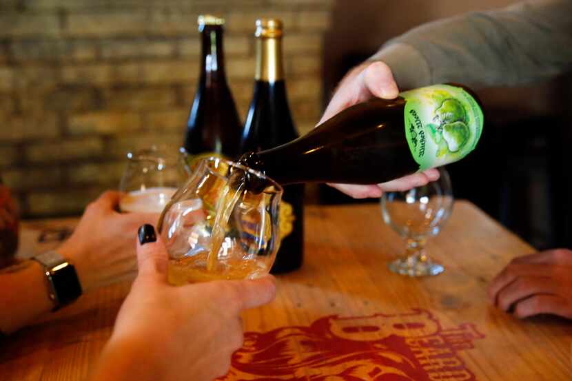 Hugh Morris pours a glass of Wicked Weed barrel-aged craft brew at The Bearded Lady in Fort...