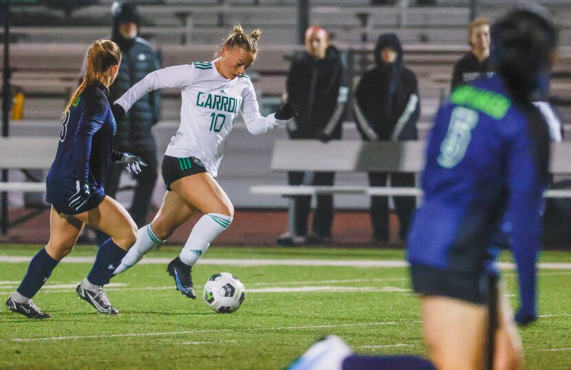 Southlake Carroll High School sophomore midfielder Kennedy Fuller (10) dribbles the ball...