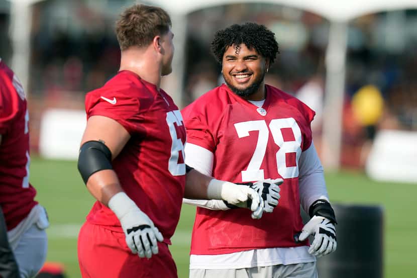 Tampa Bay Buccaneers tackle Tristan Wirfs (78) laughs with fellow tackle Luke Goedeke during...