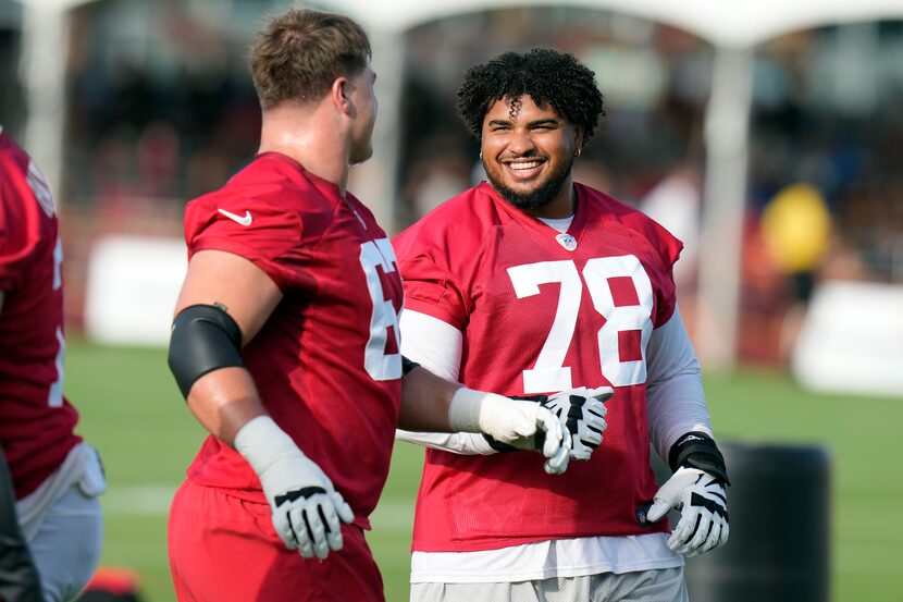 Tampa Bay Buccaneers tackle Tristan Wirfs (78) laughs with fellow tackle Luke Goedeke during...