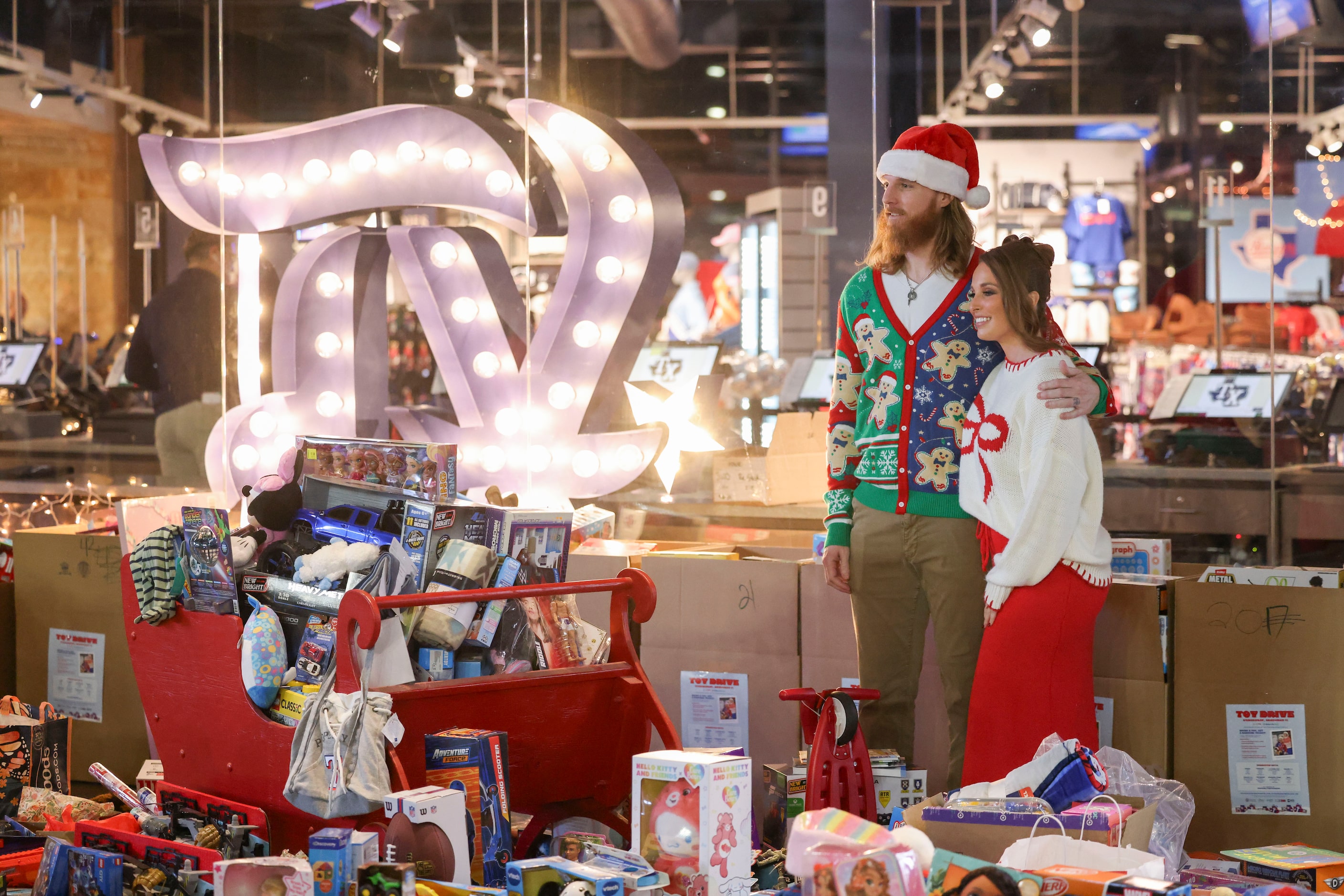 Texas Rangers pitcher Jon Gray and his wife, Jacklyn, poses for a photo with the toys from...