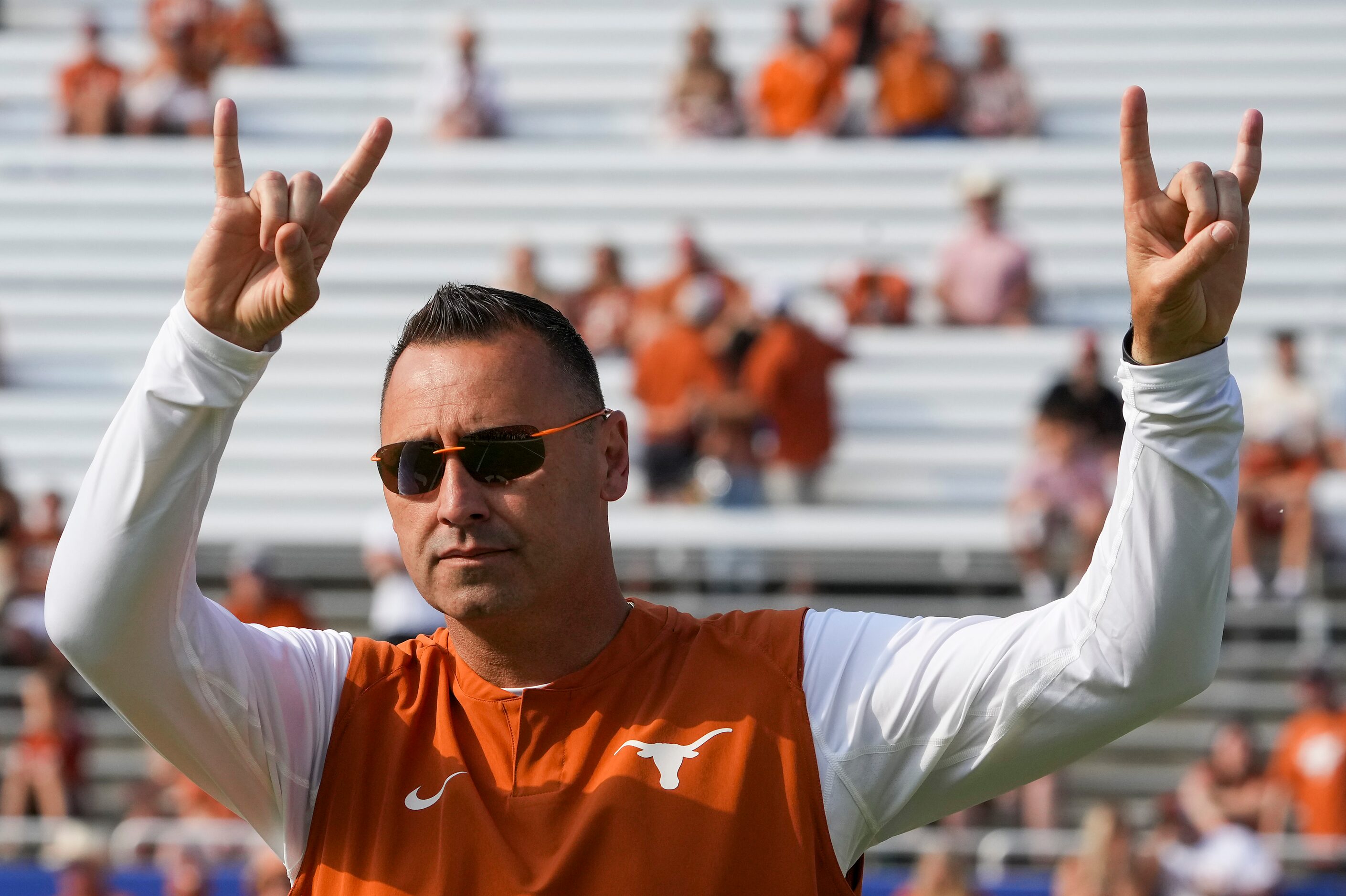 Texas head coach Steve Sarkisian gives the Hook 'em Horns sign to the crowd before the...