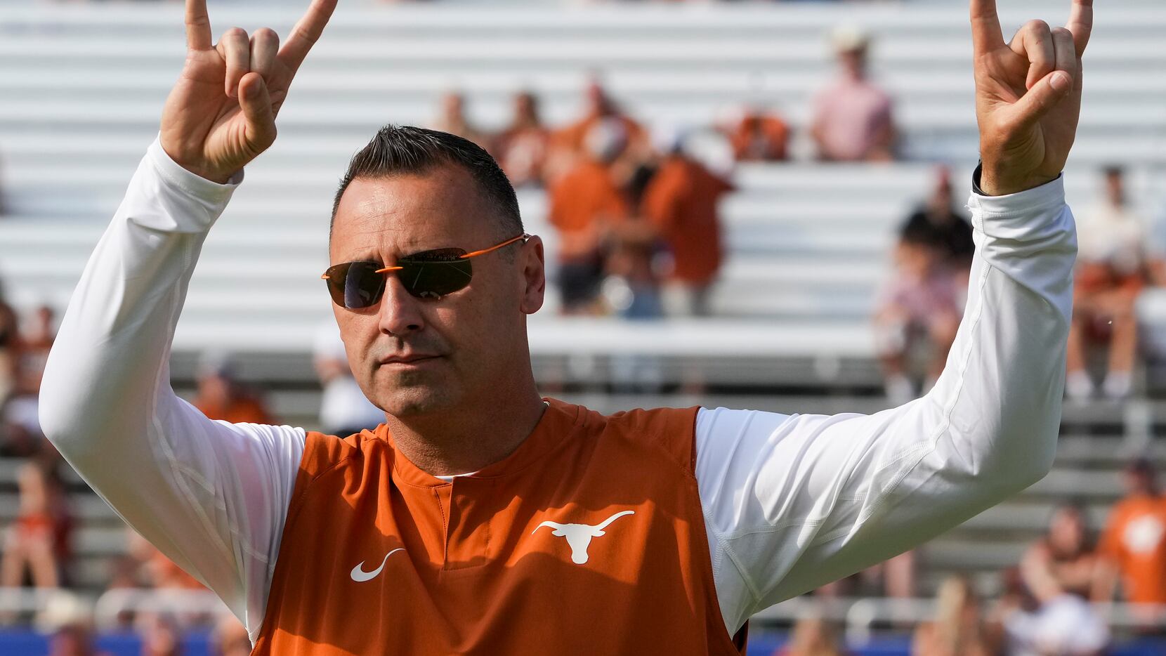 Texas head coach Steve Sarkisian gives the Hook 'em Horns sign to the crowd before the...
