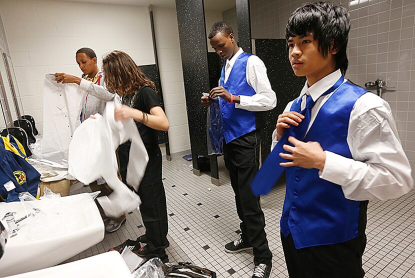  Mohamed Rashid, center, Tin Win, right, and others tried on their new clothes after The...