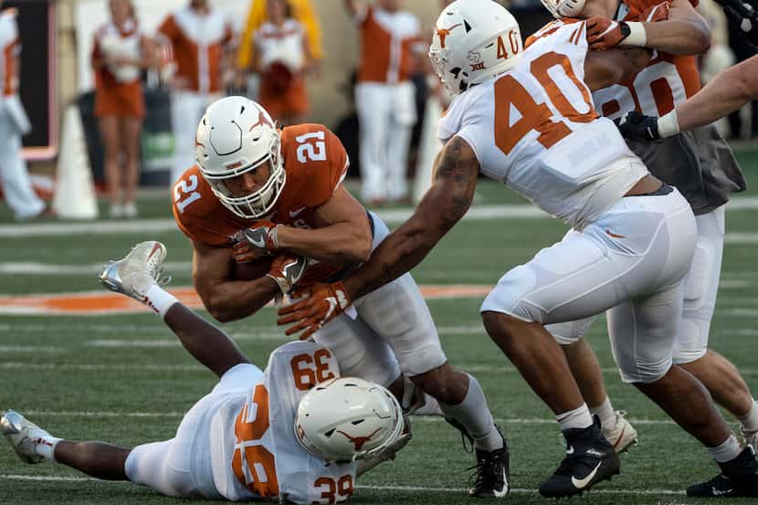 University of Texas running back Jordan Whittington (21) is tackled by defensive back...
