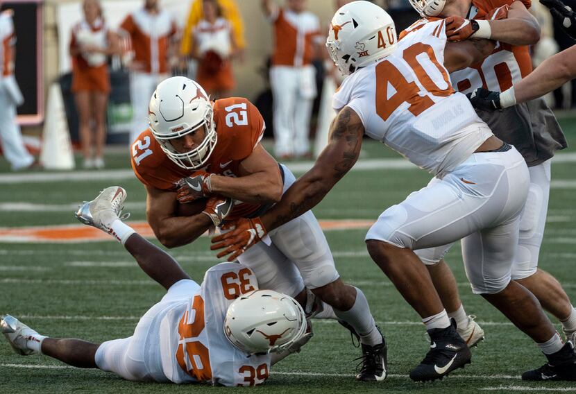 University of Texas running back Jordan Whittington (21) is tackled by defensive back...