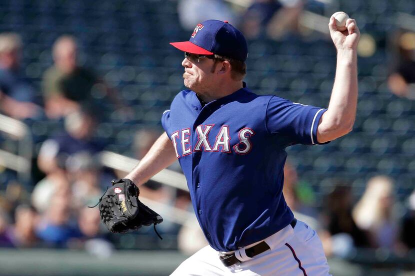 Texas Rangers starting pitcher Nate Robertson throws during an exhibition spring training...
