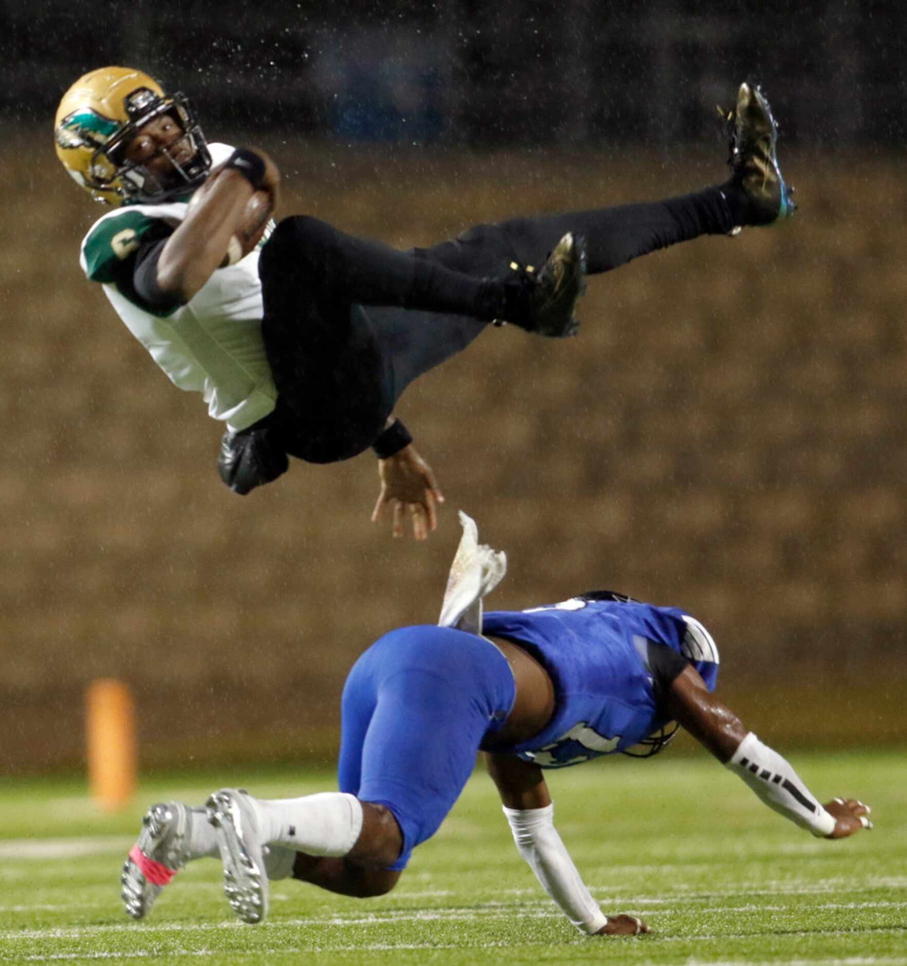 DeSoto quarterback Samari Collier (6 ) is flipped by Mansfield Summit linebacker Xavier...