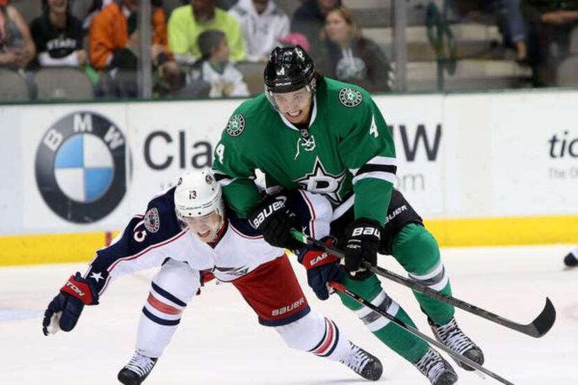 
Dallas Stars defenseman Brenden Dillon (4) battles with Columbus Blue Jackets right wing...