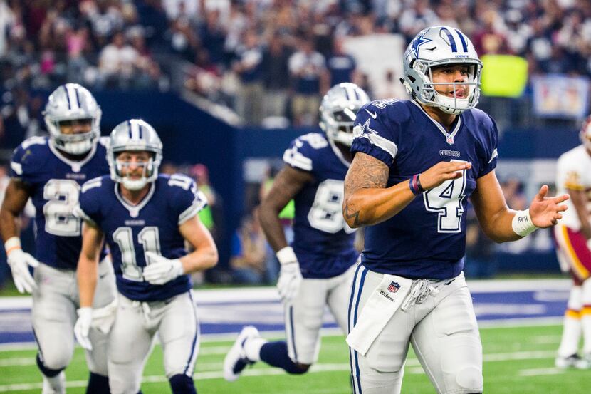 Dallas Cowboys quarterback Dak Prescott (4) celebrates a touchdown during the first quarter...