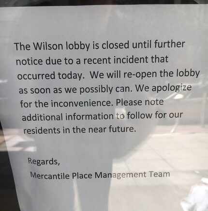 A sign on the door at the Wilson Building in downtown Dallas where a man reportedly cut two...