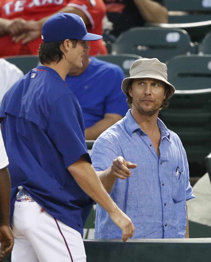 Texas Rangers starting pitcher Cole Hamels (35) talks to actor Matthew McConaughey between...
