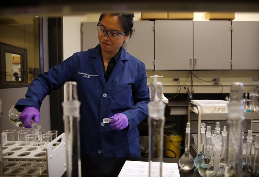 Analytical chemist Paulette Bunyapanasarn prepares samples for elemental analysis of...