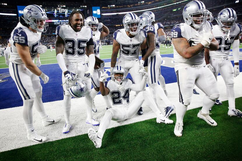 The Dallas Cowboys celebrate in the end zone after an interception against the New Orleans...