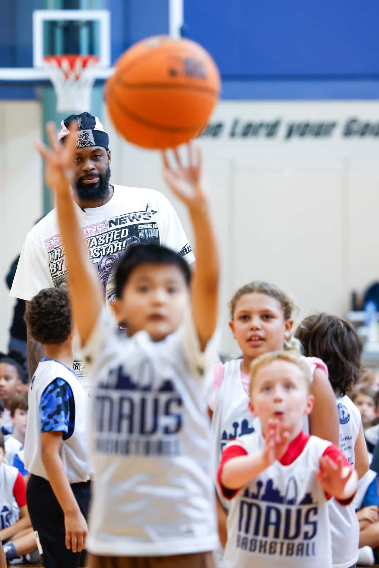 Dallas Mavericks’ Naji Marshall, watches as young basketball campers play ball during a Hoop...