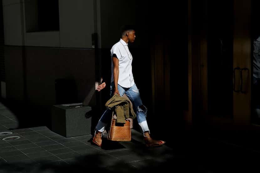 Marlena English walks into the Joule Hotel off of Commerce Street on July 7. 