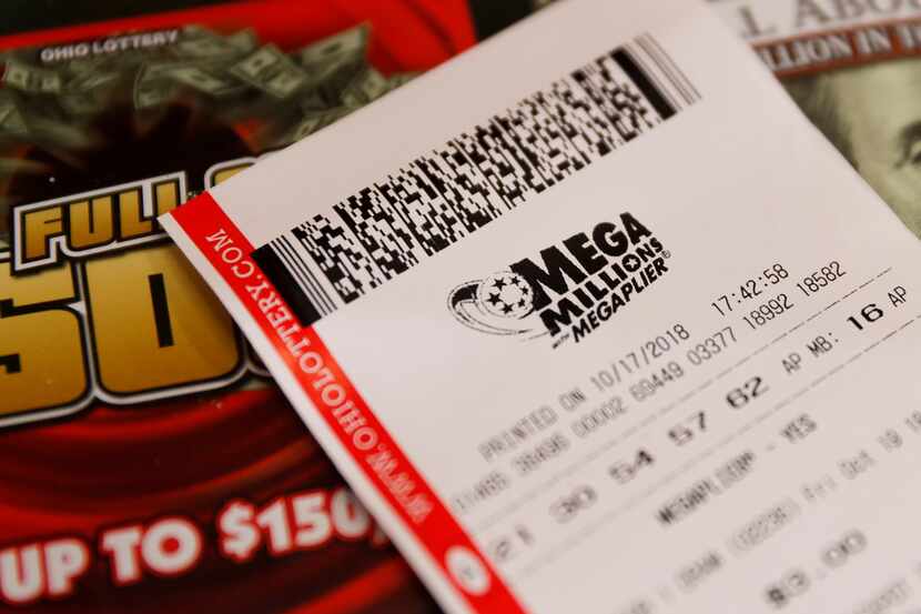 A Mega Millions lottery ticket rests on a counter at the Street Corner Market  in...