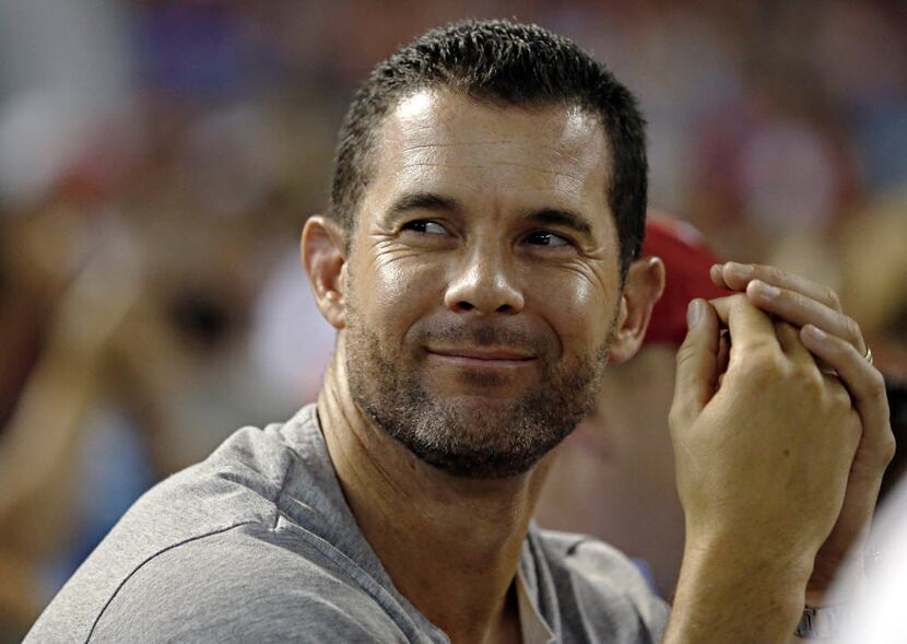 Former Texas Rangers player Michael Young watches the game during the ninth inning against...