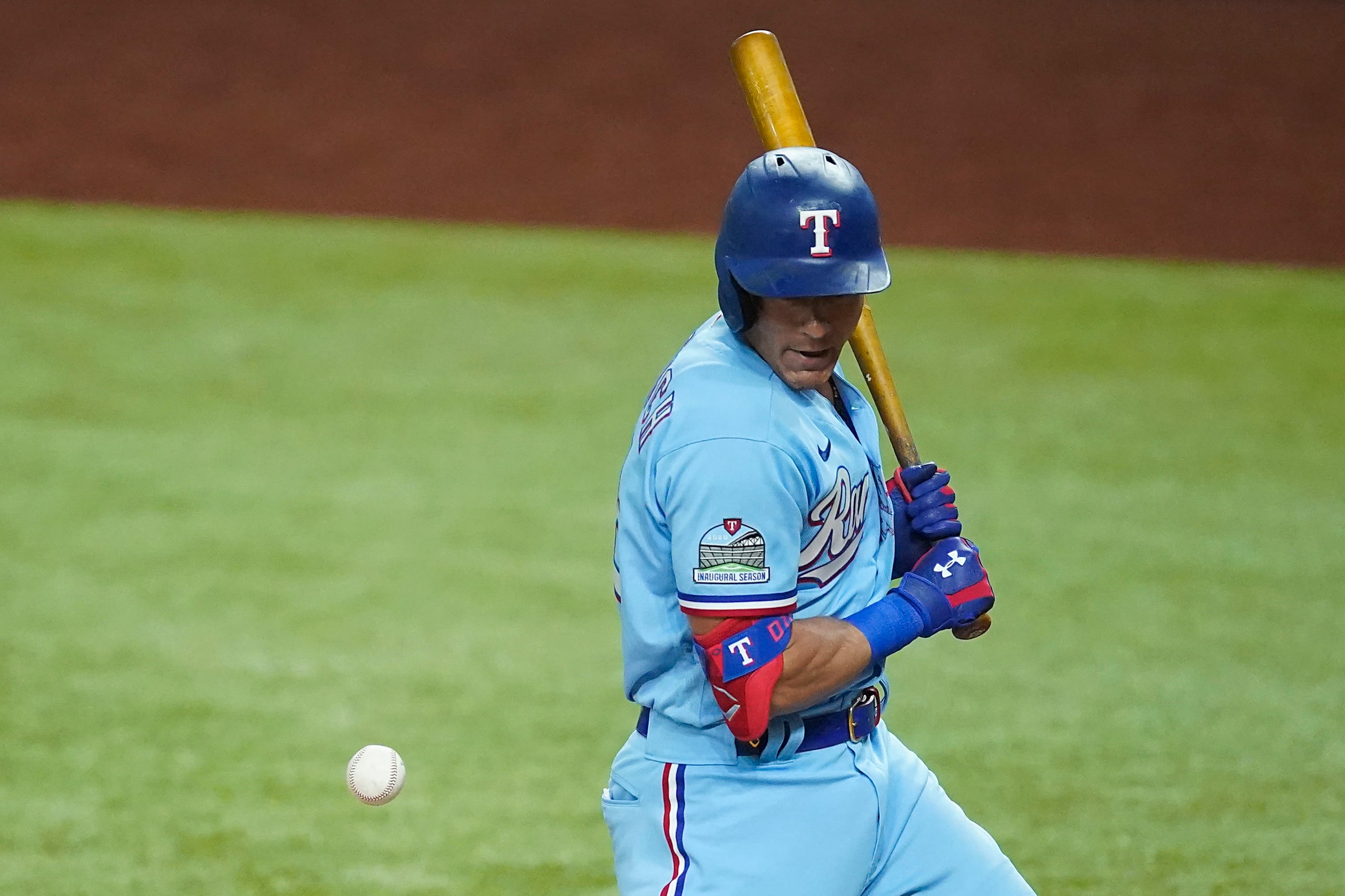 Texas Rangers third baseman Derek Dietrich is hit by a pitch during the eighth inning...