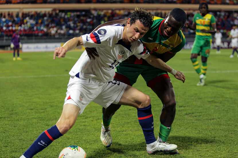 U.S. Brenden Aaronson, left, fights for the ball with Grenada's Benjamin Ettienne, during a...