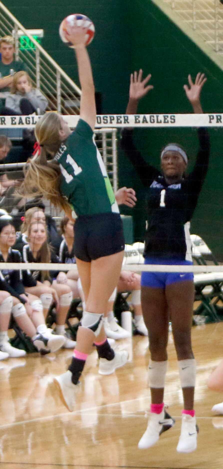 Prosper's Shaylee Shore (11) skies to spike against the defense of Iman Ndiaye (1) during...