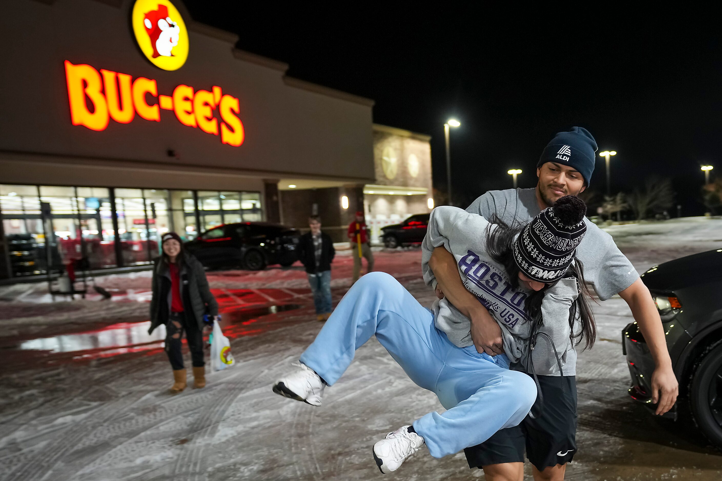 Letzie Corro is carried to the car by fellow TWU student Jesus Vazquez after picking up...