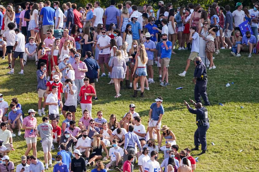 Law enforcement clears SMU students from the hill in the south end zone during the first...