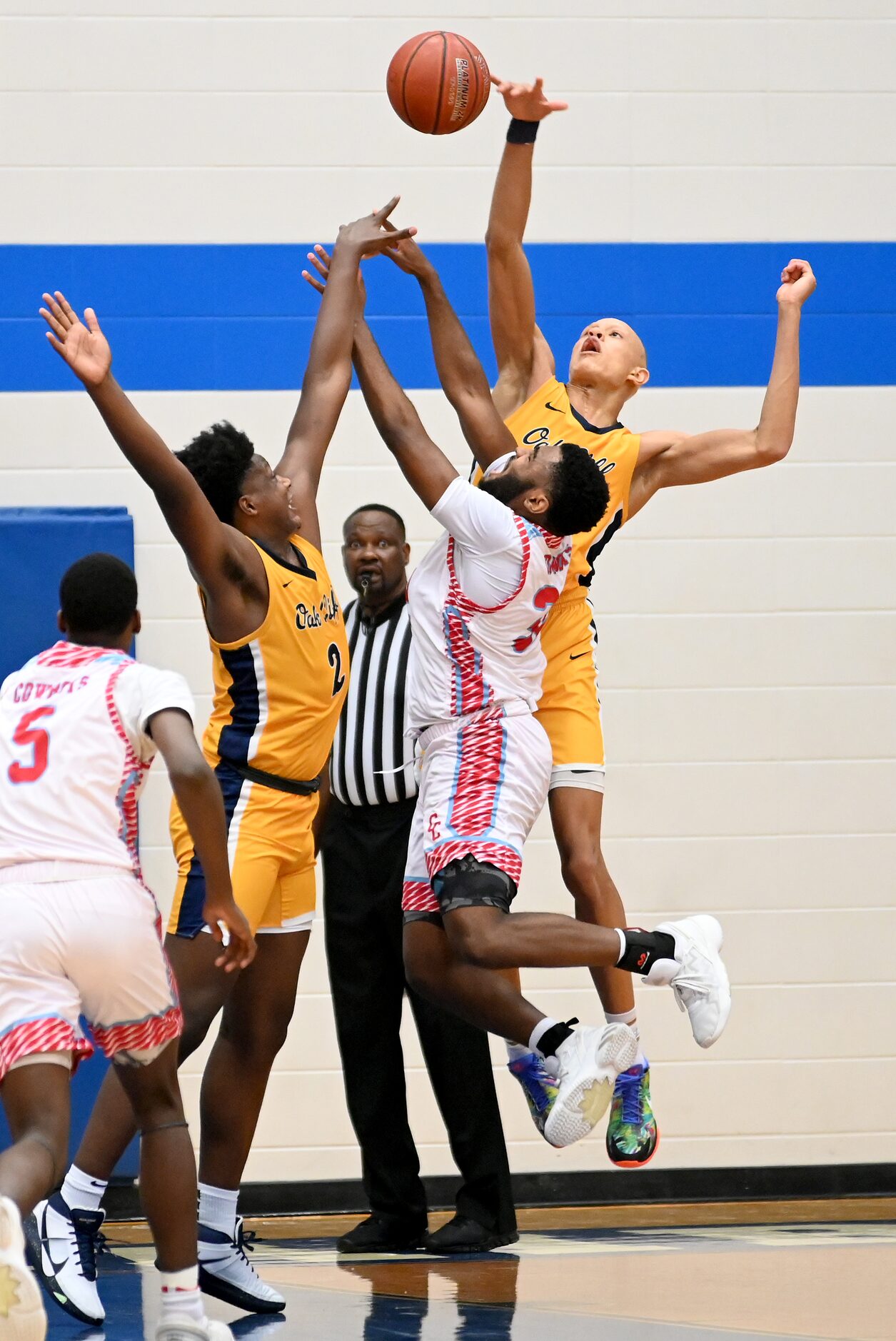 Faith Family’s Jordan Walsh, back right in yellow, blocks a shot by Carter’s Walter Taylor...