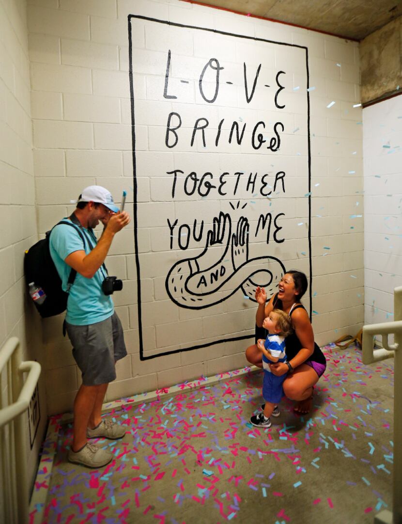 Brian Frank tossed confetti as he photographed his wife Jeanette and son Harvey during a...