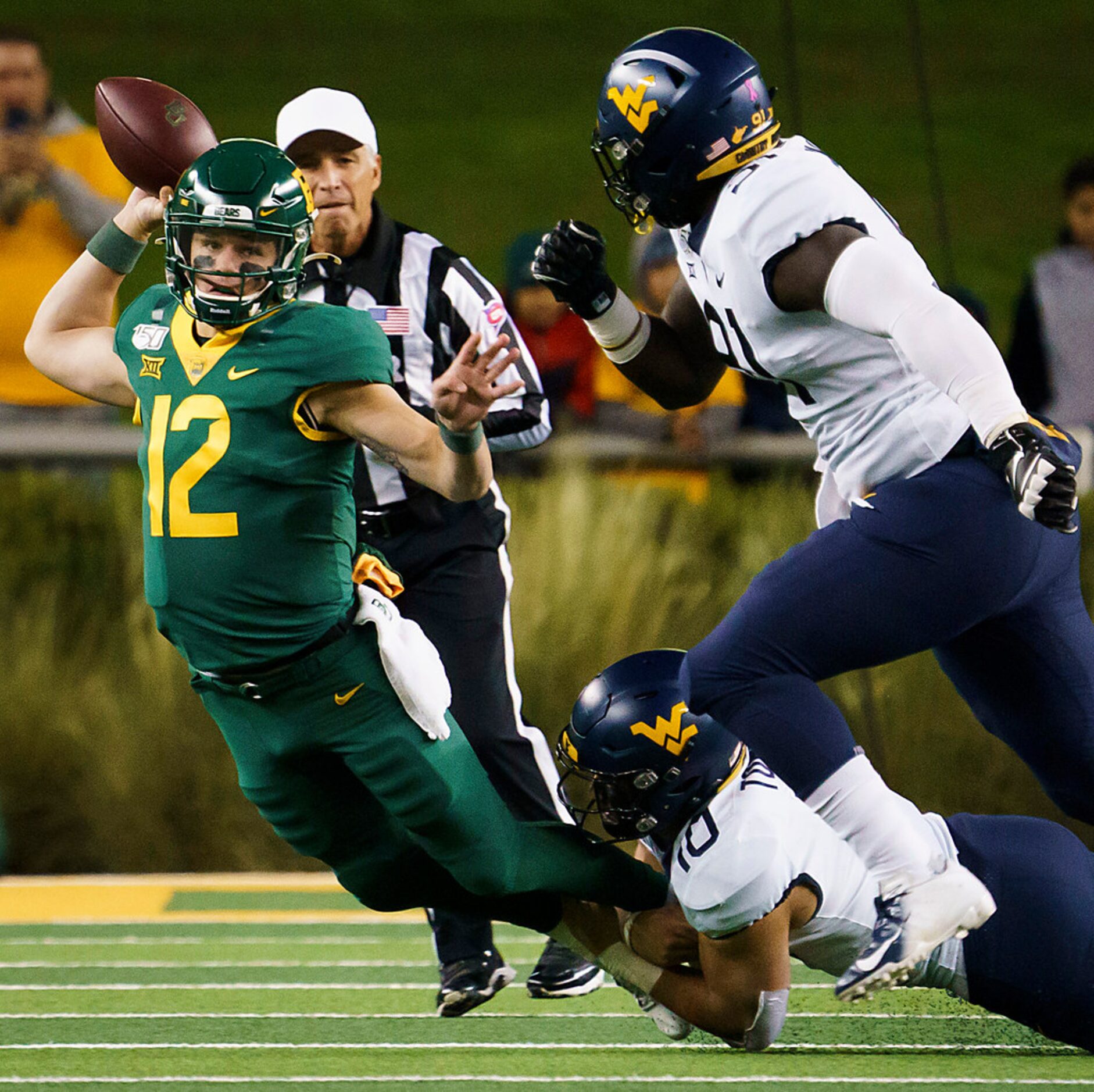 Baylor quarterback Charlie Brewer (12) gets off a pass as he is chased down by West Virginia...