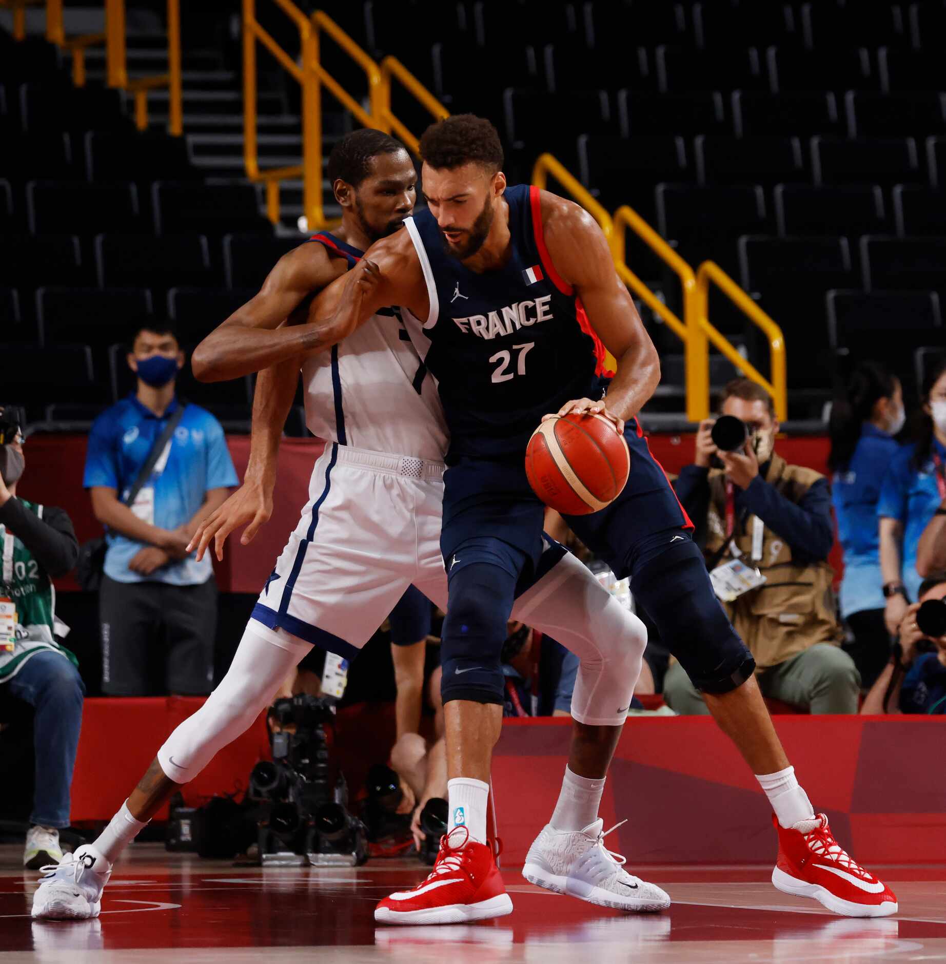 USA’s Kevin Durant (7) defends as France’s Rudy Gobert (27) posts up during the first half...