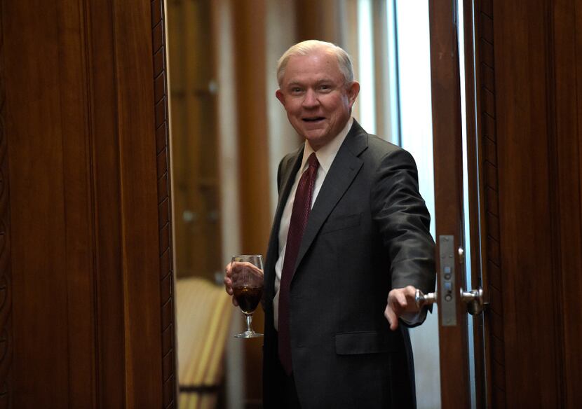 Attorney General Jeff Sessions peeks into his conference before a meeting at the Department...