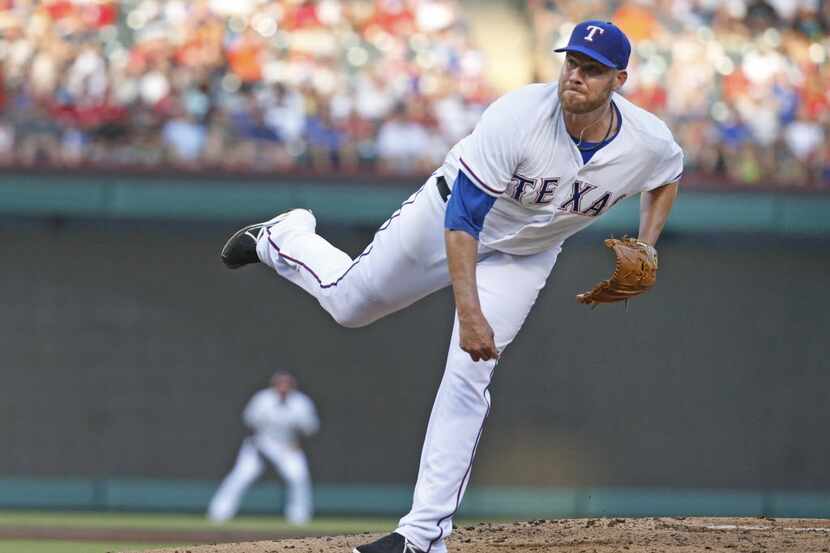 Texas Rangers starting pitcher Colby Lewis (48) throws a third-inning pitch during the New...