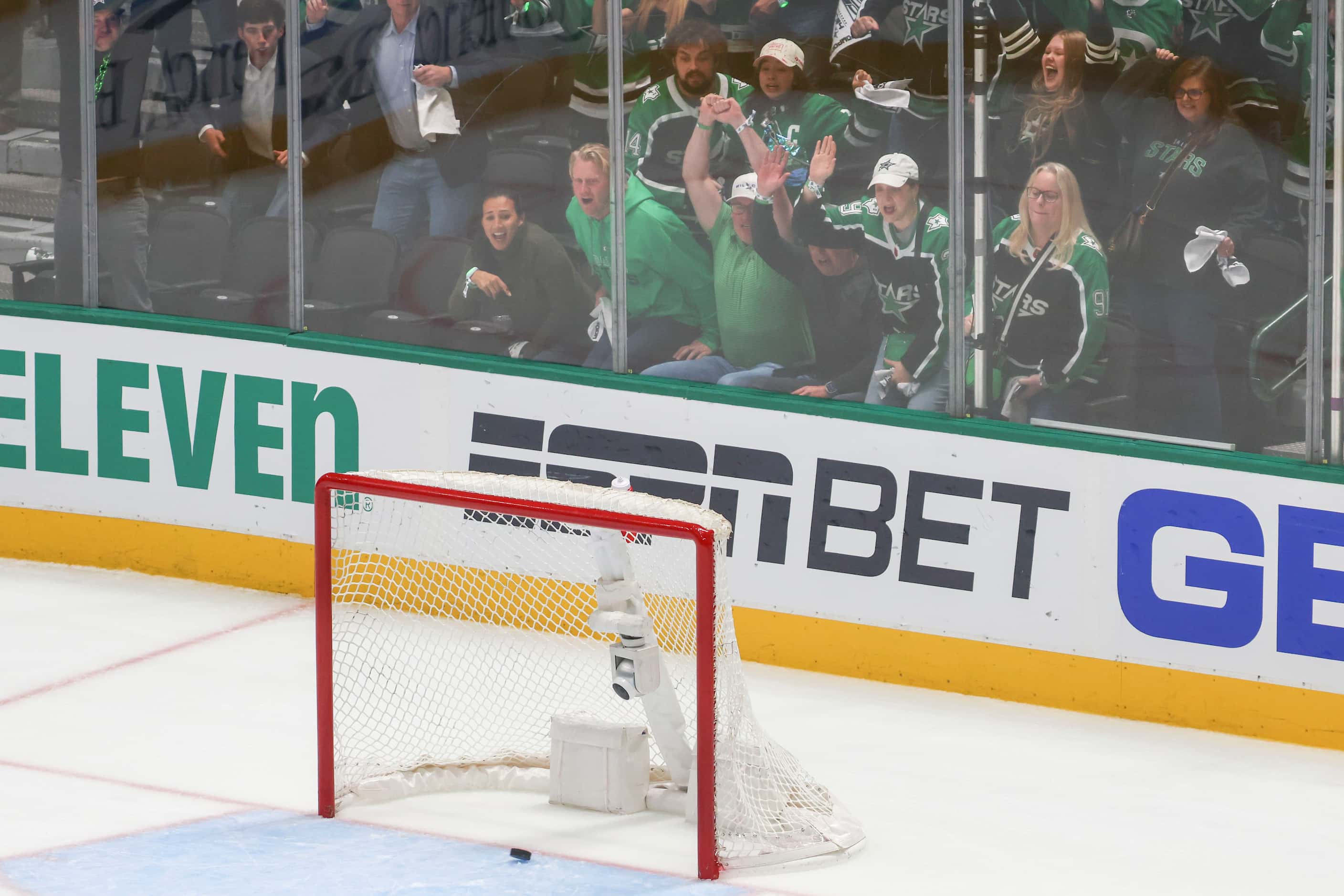 Crowd cheer as they watch a shot by Dallas Stars defenseman Esa Lindell goes into the...