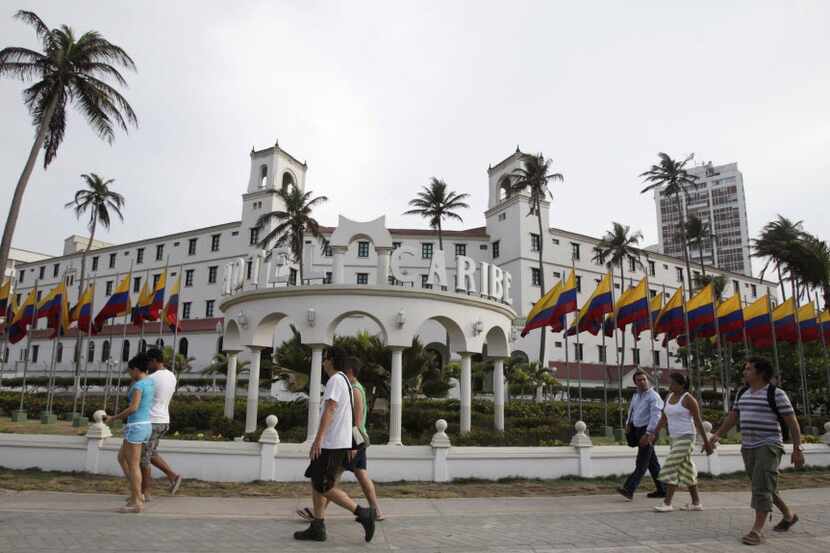 People walk past Hotel El Caribe in Cartagena, Colombia, Saturday April 14, 2012. 