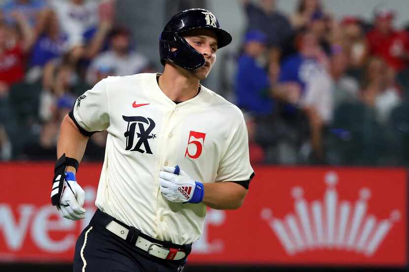 Texas Rangers' Corey Seager (5) runs the bases after hitting a home run against the Los...