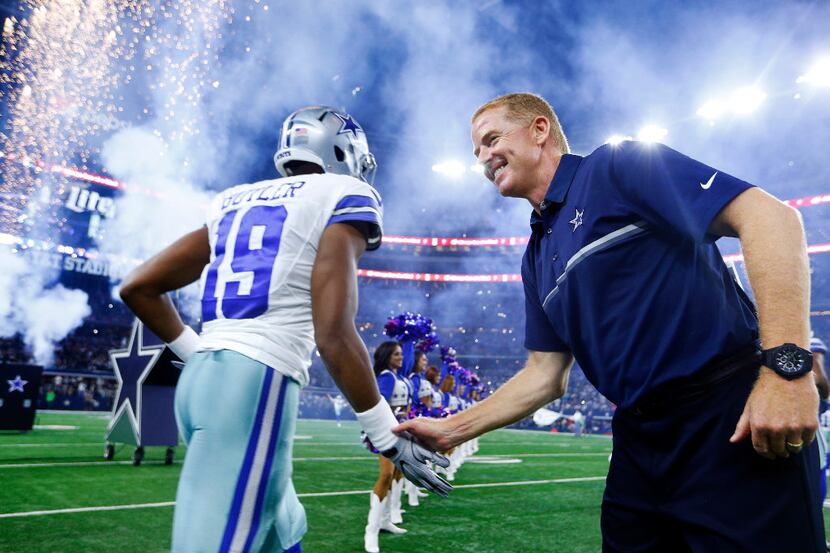 Dallas Cowboys head coach Jason Garrett slaps hands with wide receiver Brice Butler (19)...