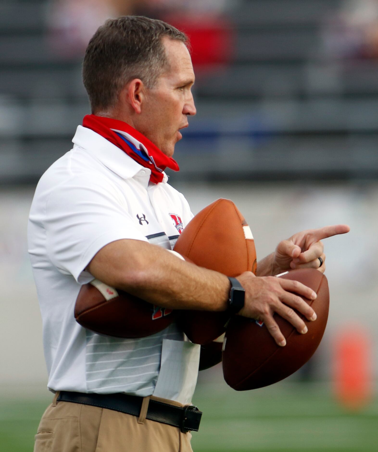 Midlothian Heritage head football coach Lee Wigginton makes a point while working with his...