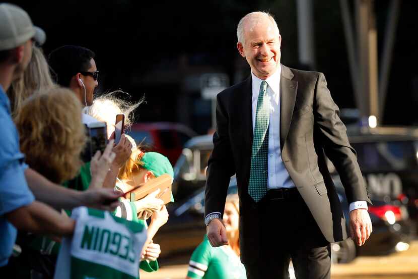 Dallas Stars general manager Jim Nill welcomed by fans on the green carpet at the American...