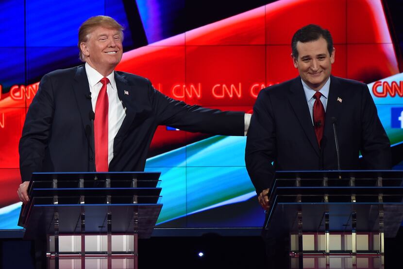  Donald Trump pats Sen. Ted Cruz during the Republican debate in Las Vegas on Dec. 15. (AFP...
