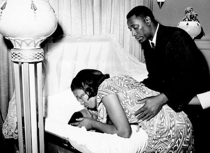  Myrlie Evers, the widow of civil rights activist Medgar Evers, leans down to kiss her late...