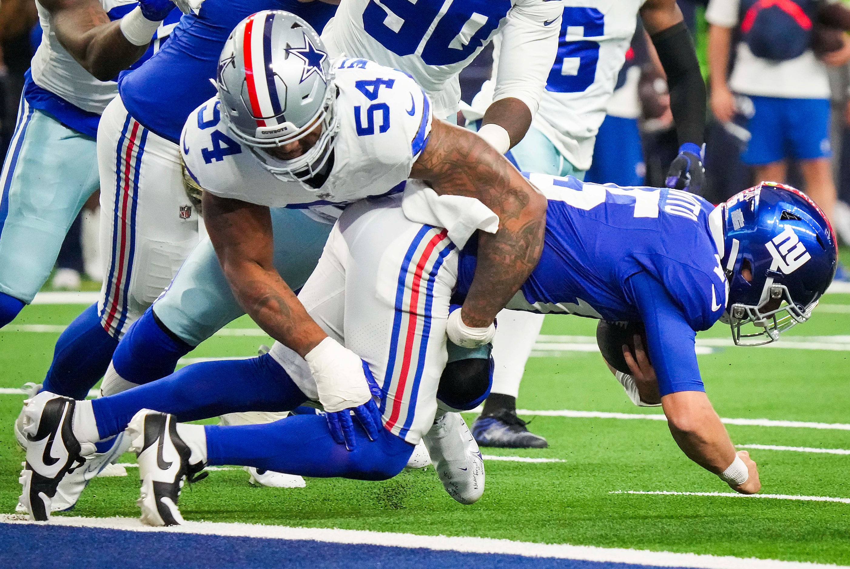 New York Giants quarterback Tommy DeVito (15) is sacked by Dallas Cowboys defensive end Sam...