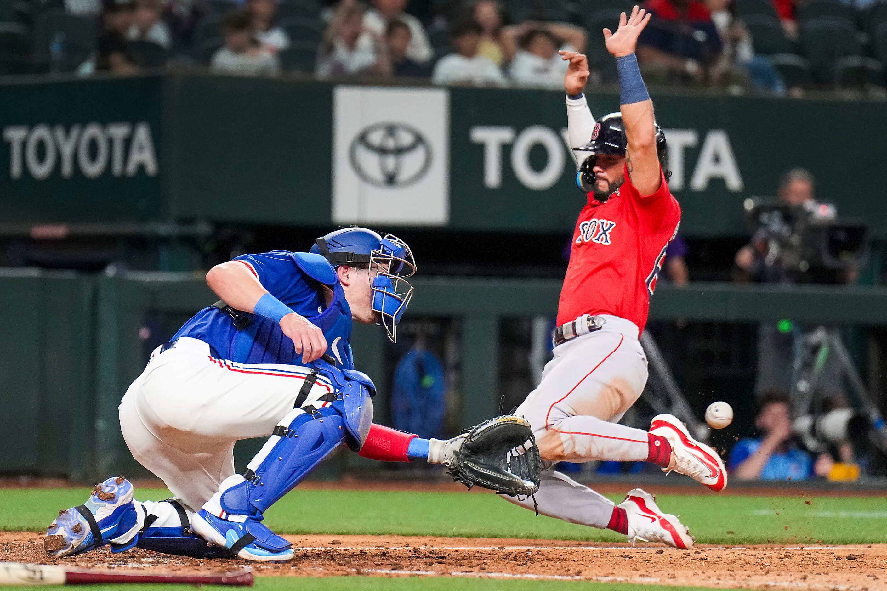 Eddy Alvarez of the Boston Red Sox scores from third base on a fielders choice ahead of the...