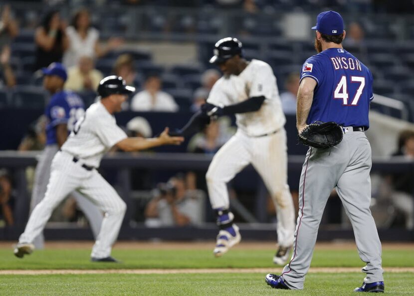 Texas Rangers relief pitcher Sam Dyson (47), who took the loss, watches as New York Yankees...