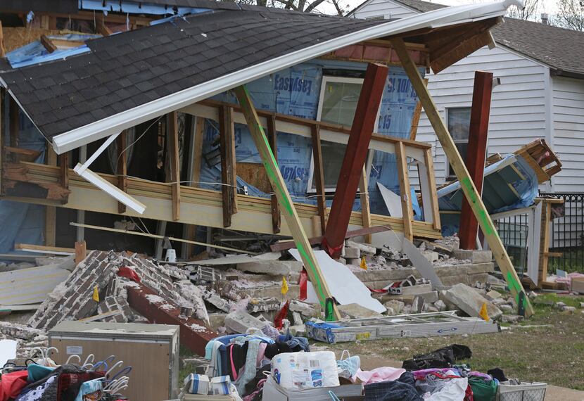 The rubble of a house at 3534 Espanola Drive now sits behind a security fence because of an...