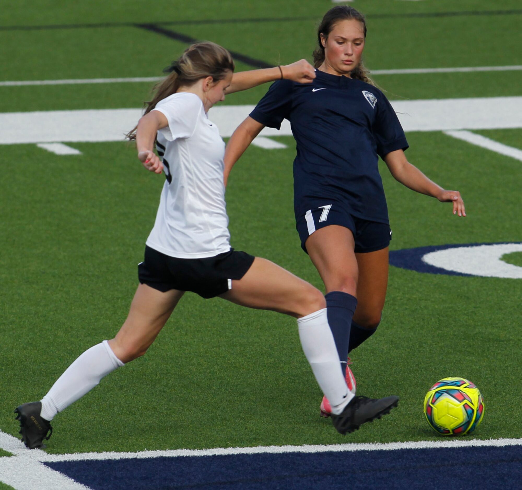 Flower Mound's Sydney Beccara (7), right, challenges Flower Mound Marcus' Kelly VanGundy...